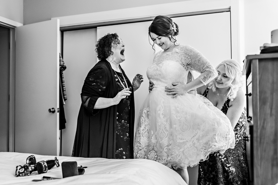 The mother of the bride laughs with excitement during the getting ready.